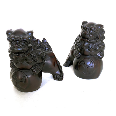 Pair of Fu Dogs with yin and yang symbol, cast resin, Chinese, 20th century